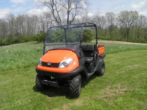 3 Star 2-piece windshield installed on an orange Kubota RTV, front three-quarter view on a grassy field