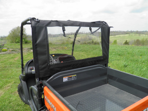 Close-up from the bed of the 3 Star soft back panel with clear window rolled up on an orange Kubota RTV
