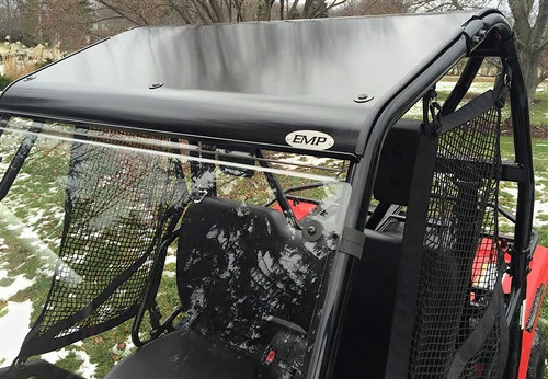 Extreme Metal Products black aluminum top installed on a red Honda Pioneer 500, side view showing roof and windshield in snow