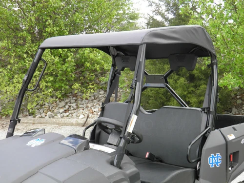 Close passenger side view of the 3 Star soft top over the roll cage and seats of the gray Kymco 450