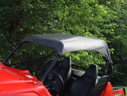 3 Star black soft top stretched over the roll cage of a red Polaris RZR 900, side close-up with trees behind