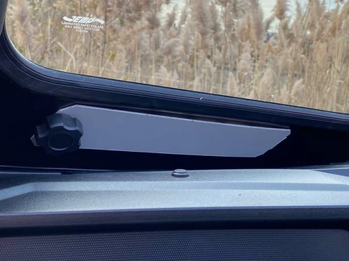 Close-up of the slide vent and knob in the corner of the Extreme Metal Products glass windshield on the Teryx KRX