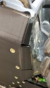 Close-up of the Trail Armor integrated side skid plate along the rocker of a Kawasaki Teryx KRX