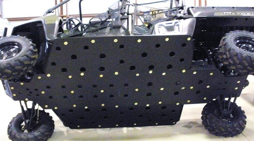 Trail Armor full skid plate with dimpled bolt pattern installed under a Polaris Ranger 800 Crew, side view in a shop