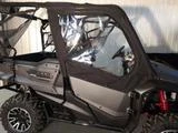 Side view of a black Honda Pioneer 1000 with Side X Side upper doors showing the clear door windows