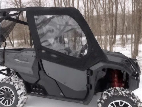 Side X Side upper doors kit installed on a black Honda Pioneer 1000 in snow, front three-quarter view