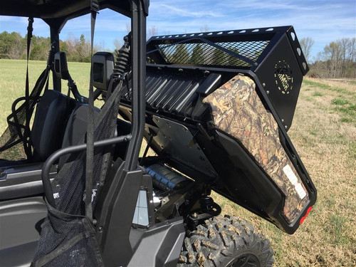 Trail Armor small rear basket storage mounted on a camo Can-Am Defender with the cargo bed tilted up