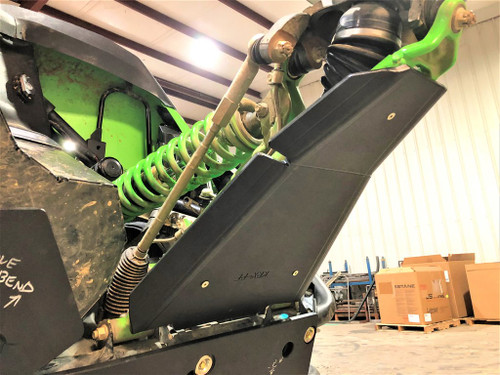 Trail Armor iMpact front guard bolted to the green lower A-arm of a Kawasaki Teryx KRX in a shop, side view
