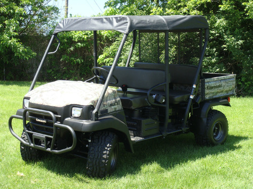 Wider front three-quarter view of the Kawasaki Mule 3000/3010 Trans with the 3 Star soft top on a lawn