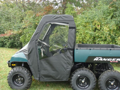 3 Star full cab enclosure with vinyl windshield and soft doors on a green six-wheel Polaris Ranger, side view on grass