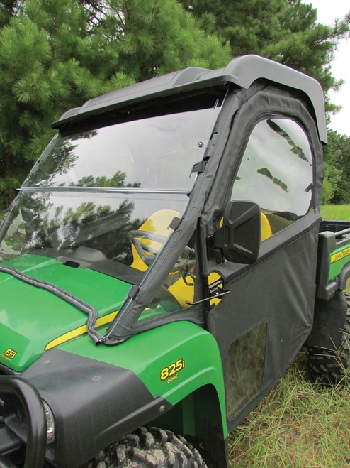 Front three-quarter view of a green John Deere Gator XUV with the Seizmik hinged door closed and windshield