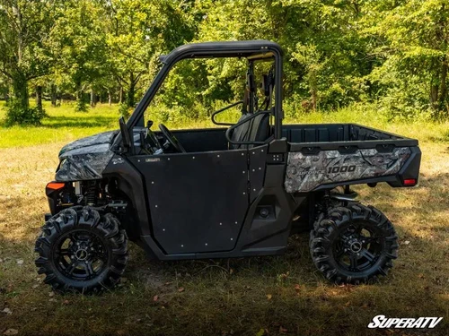 SuperATV black aluminum half doors installed on a camo CF Moto UForce 1000 in a wooded clearing, side view