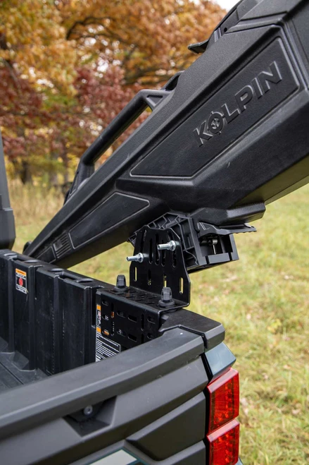 Kolpin Stronghold Auto-Latch mount holding a gun boot on the bed rail of a Polaris side-by-side