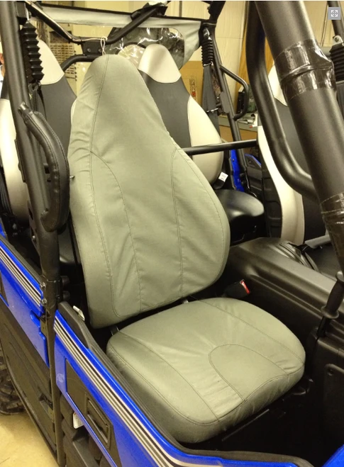 Greene Mountain gray seat cover fitted over a bucket seat in a blue Kawasaki Teryx 4, viewed through the open door