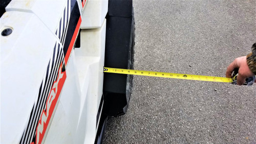 Tape measure showing how far the Trail Armor rear fender extension projects from a white Yamaha Wolverine RMAX 2