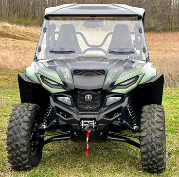 Spike Powersports over-fenders on a green Yamaha R-Max, front view in a field
