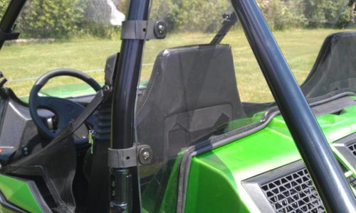 Side view through the cab showing the rear window panel behind the seats of the green Arctic Cat Wildcat 1000