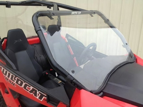 Extreme Metal Products windshield installed on a red Arctic Cat Wildcat Trail, front three-quarter view in a shop