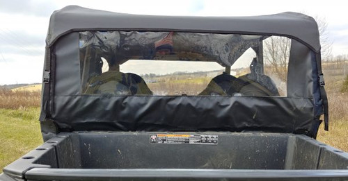 3 Star soft back panel with wide clear window installed behind the rear seats of a Polaris General Crew, view over the bed