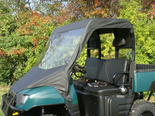 3 Star vinyl windshield and top installed on a dark green Polaris Ranger 700, close driver side view of the cab