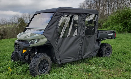 3 Star black soft cab enclosure with doors and windows on a green Can-Am Defender Max in a field, side view