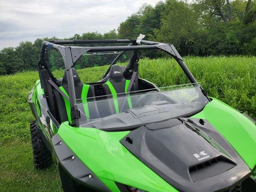 3 Star half windshield installed on a green Kawasaki KRX, front three-quarter view with the roll cage above