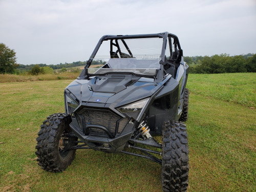 3 Star tinted half windshield installed on a black Polaris RZR Pro XP, front three-quarter view in a field