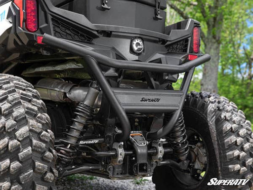 SuperATV rear bumper installed on a Can-Am Maverick Trail, close rear view with mud tires and exhaust visible