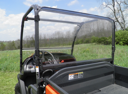3 Star Lexan rear window installed on an orange Kubota 400/500, clear panel seen from the cargo bed with cab behind