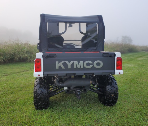 Rear view of the white Kymco 700 in a foggy field with the 3 Star soft back panel and soft top installed