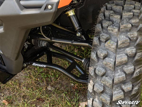 SuperATV high clearance forward offset A-arm installed on a CF Moto U-Force 1000, close-up behind the front tire
