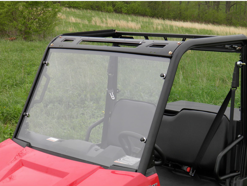 3 Star two-piece windshield installed on a red side-by-side under a roof, close driver side front view