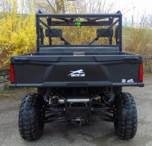 Straight rear view of the black Arctic Cat Prowler Pro with the 3 Star Lexan rear windshield, yellow bushes behind