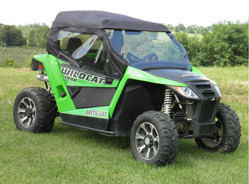 3 Star soft top and upper doors with clear windows installed on a green Arctic Cat Wildcat Trail, front three-quarter view