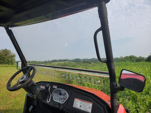 View from the driver seat through the 3 Star 2-piece windshield of a Coleman 400, steering wheel and mirror