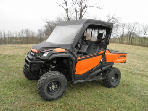 3 Star vinyl windshield and top combo on an orange Honda Pioneer 1000, front three-quarter view in a field