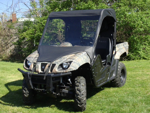 3 Star vinyl windshield, soft top and rear window on a camo Yamaha Rhino, front 3/4 view on grass
