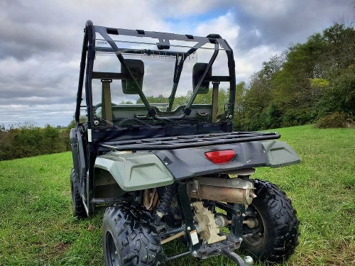 3 Star clear Lexan rear window installed on a green Honda Pioneer 500/520, rear three-quarter view above the rack