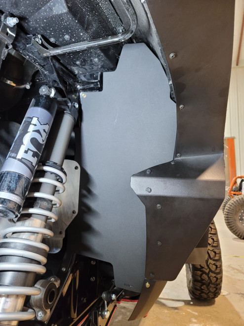 Trail Armor fender liner installed inside the rear wheel well of a Kawasaki KRX next to the shock, wheel removed