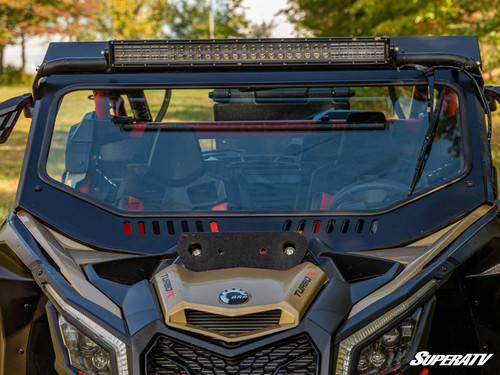 SuperATV glass windshield installed on a tan and black Can-Am Maverick X3 with a light bar, front view