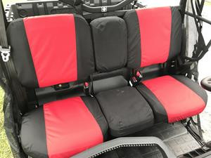 Greene Mountain red and black seat covers installed on the rear bench seat of a Can-Am Defender MAX Limited, side view