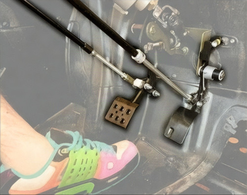 Sure Grip universal hand controls installed in a UTV footwell, push rods linked to the brake and gas pedals