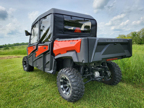 3 Star full cab enclosure on an orange Intimidator GC1K 6-seater, rear three-quarter view in a field