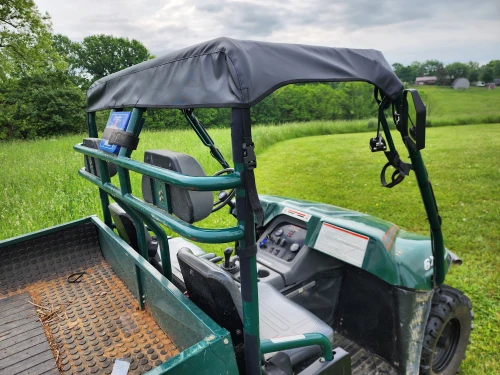 3 Star soft top of the full cab enclosure on a green 1999 Polaris Ranger 6x6, viewed from the cargo bed