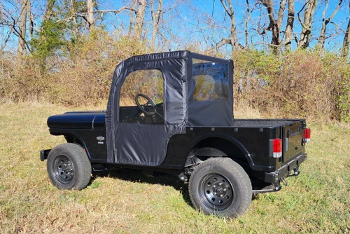 3 Star full doors and rear window combo on a black Mahindra Roxor, rear three-quarter view in a field