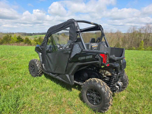 3 Star full doors on a black Can-Am Maverick Trail parked in a field, rear three-quarter view