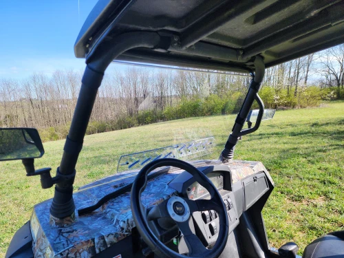 3 Star one-piece scratch-resistant windshield on a camo HiSun Strike 1000 Crew seen from inside over the steering wheel