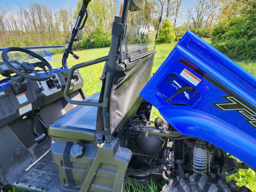 3 Star polycarbonate rear windshield on a blue Massimo T-Boss 410 seen from the side with the cargo bed tilted up