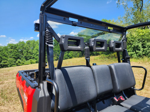 3 Star polycarbonate rear windshield mounted behind the bench seat of a red TGB LandMax 1000, inside view