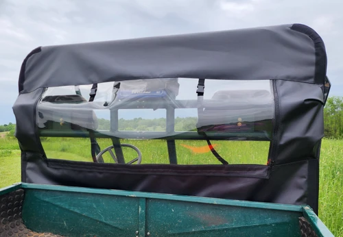 3 Star rear panel with clear vinyl window seen from the cargo bed of a green 1999 Polaris Ranger